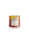 Yashi Aura candle in blown glass with orange, red and amber swirls, cream label, on a light background