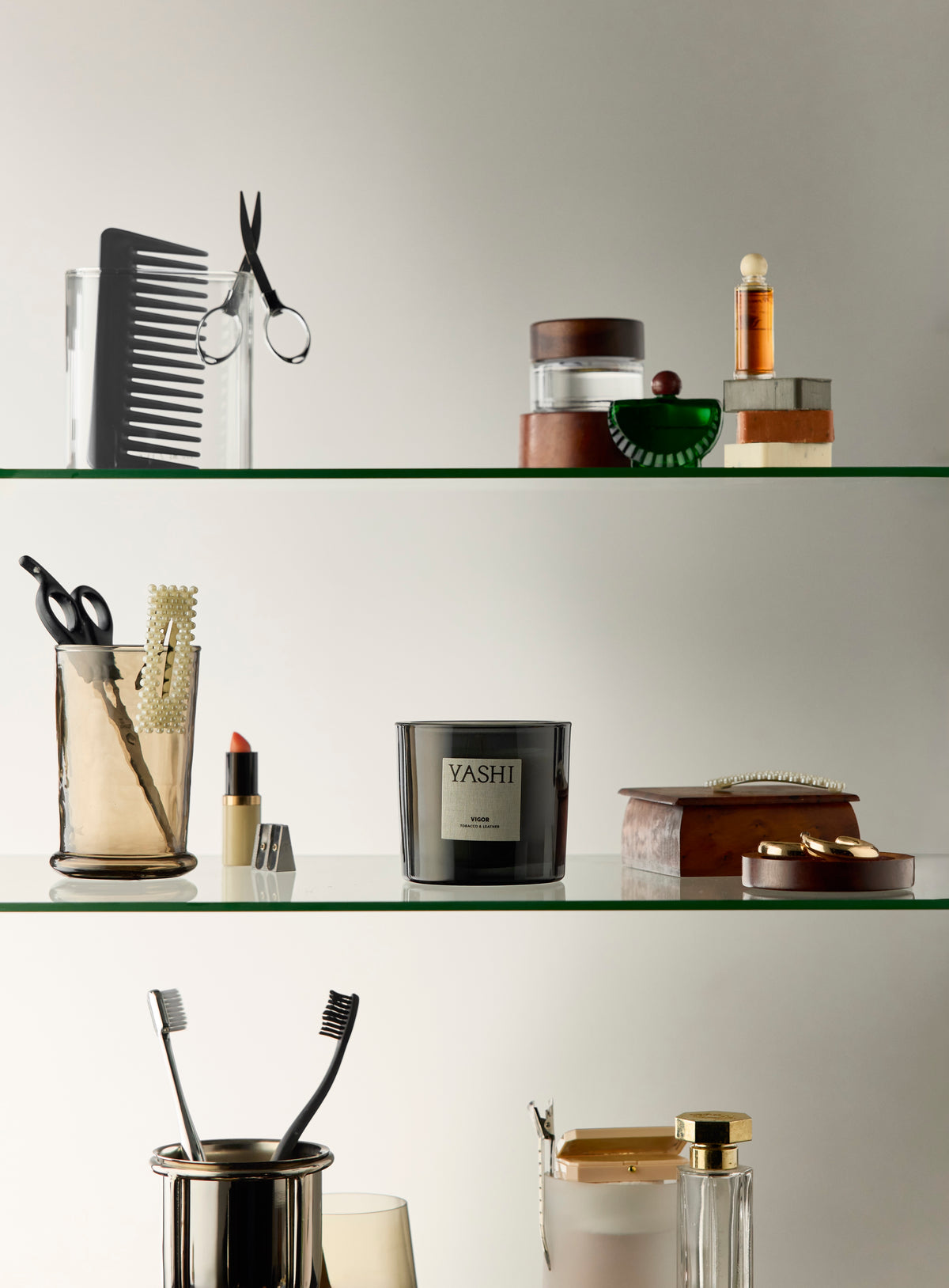Murmure de Vigor on a bathroom shelf, among a comb, a lipstick and small jars